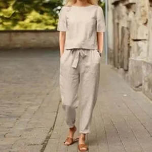 Casual beige two-piece outfit featuring a short-sleeve top and matching trousers.