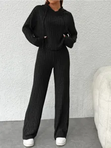 Vue détaillée du pull à capuche en tricot côtelé noir et du pantalon large pour femmes.