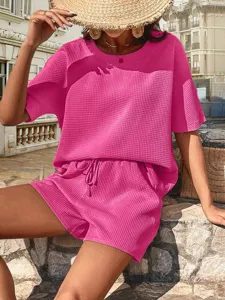Detail view of hot pink waffle knit two-piece set featuring short sleeve top and shorts.