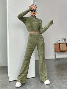 Detailed view of the olive green ribbed knit top and pants set, featuring a stylish high collar.