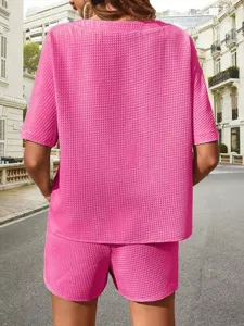 Pink waffle knit short sleeve top and matching shorts set, casual two piece outfit detail view.