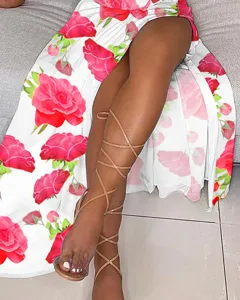 Summer bohemian floral print midi dress featuring a high slit paired with chic strappy sandals.