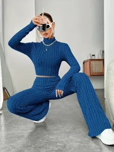 Detail view of a stylish blue ribbed knit two-piece set, featuring a cozy crop top and pants.