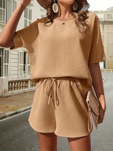 Stylish waffle knit two-piece set featuring batwing sleeve top and matching shorts for women.