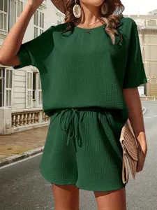 Green waffle knit two-piece set detail, casual short sleeve top and shorts outfit.