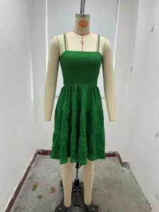 Green textured spaghetti strap tiered mini dress detail shot showing smocked bodice.