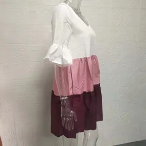 Detailed view of the colorblock V-neck tiered dress, showing ruffles and fabric texture.