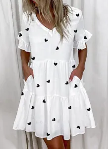 Women white V-neck tiered mini dress with black heart print short ruffle sleeves pockets.