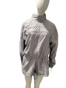Detailed view of the women long sleeve zip jacket and shorts tracksuit set in light grey.