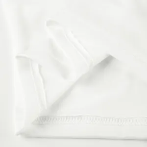 Close-up detail of premium white fabric with fine stitching for casual sportswear apparel.