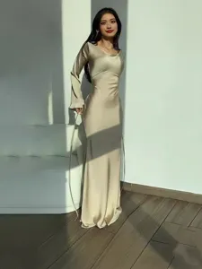 Elegant long sleeve satin dress with crewneck and waist-cinching tie design for women.