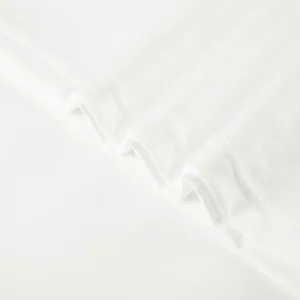 Close-up view of premium white athletic apparel fabric texture and neat double stitching detail.