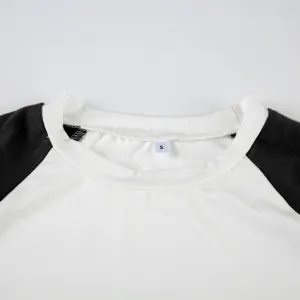 Detail view of a classic raglan short sleeve top with contrasting color sleeves and collar.
