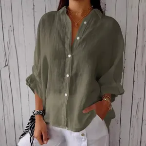 Close-up detail of the army green button-down shirt, showcasing the texture and collar style.