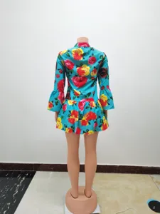 Back detail of turquoise floral print dress with bell sleeves and tiered ruffle hemline.
