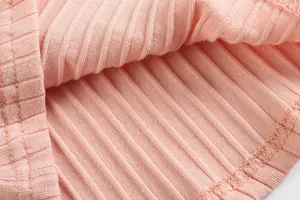 Pink ribbed knit fabric detail of women dress, soft texture with clear vertical lines.