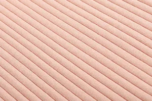 Detailed view of soft pink ribbed knit fabric texture, perfect for stylish women's dresses.