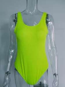 Detail view of the neon green crinkle one-piece swimsuit featuring unique seersucker texture.