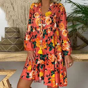 Detailed view of the vintage floral tiered dress featuring long sleeves and a relaxed bohemian hem.