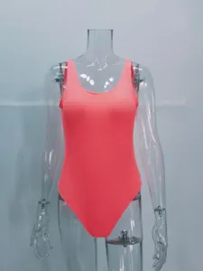 Detailed view of women neon pink crinkle one-piece swimsuit, textured fabric close-up.