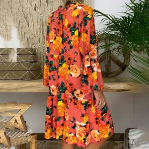 Detailed rear view of women's vintage floral tiered long sleeve dress with half collar.