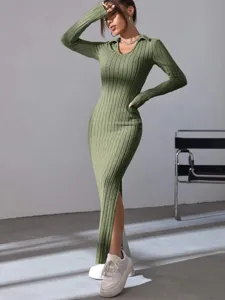 Detail of the elegant long sleeve ribbed knit midi dress with side slit and lapel collar.