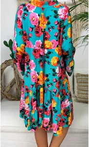 Detailed back view of women's floral printed long sleeve tiered dress in boho studio setting.