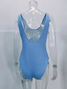 Back detail of blue crinkle one-piece swimsuit with scoop back and textured fabric.