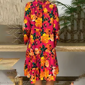 Floral print long sleeve detail showcasing vibrant yellow roses on a bold magenta fabric background.