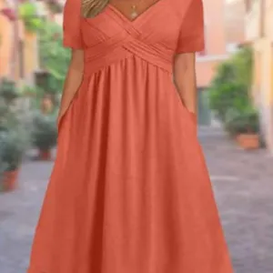 Casual women's solid color short sleeve V-neck midi dress with pockets and pleated waist.