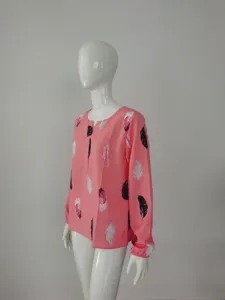 Pink V-neck long sleeve blouse with feather print detail, showing front side and soft texture.