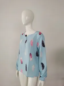Close-up detail of the light blue V-neck long sleeve blouse featuring elegant feather print.