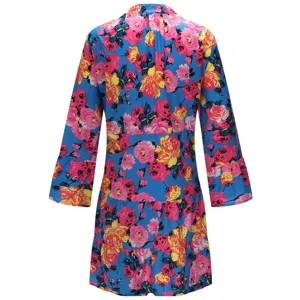 Back detail of blue floral tiered dress featuring vibrant pink roses and elegant flare sleeves.