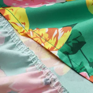 Close-up of vintage floral print women dress fabric with neat green stitching and clean overlock hem.