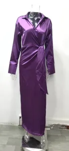 Detail shot of purple satin long-sleeve lapel dress, featuring high waist and side slit design.