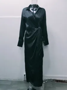 Detailed view of the elegant black long sleeve lapel high waist slit jumpsuit item.