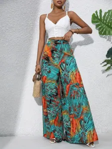 Tropical leaf printed wide leg pants detail showing fabric texture and elegant vacation style.