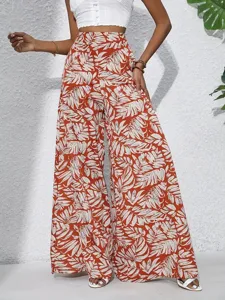 Detailed view of women summer resort style high waist tropical leaf printed wide leg pants.