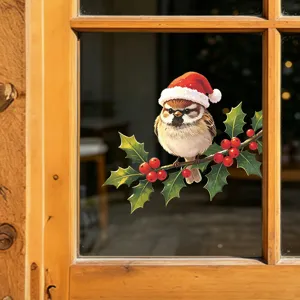 Detailed view of Christmas bird sticker with Santa hat on holly branch for window