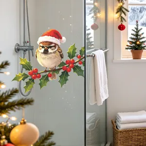 Macro view of festive bird sticker with Santa hat on holly branch on glass shower door