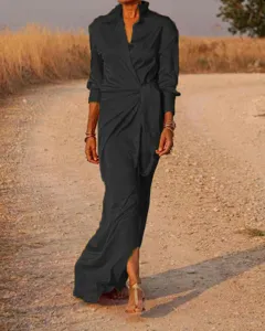 Detailed view of women's long sleeve lapel high waist slit jumpsuit in outdoor scenery.