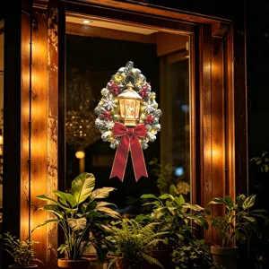 Christmas wreath window sticker with lit golden lantern, red bow, and berries decoration