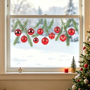 Christmas window decals with red ornaments and pine branches on a snowy backdrop