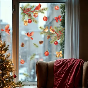 Festive cardinal and pinecone Christmas window stickers shown on glass in a cozy living room