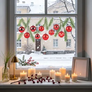 Christmas window stickers featuring red baubles and pine branches on a winter window