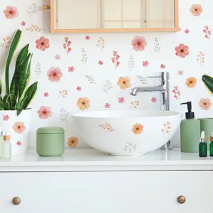 Detailed view of pink and orange floral wall stickers in a bathroom setting.