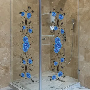 Detailed view of blue rose vine wall stickers applied to a glass shower door.