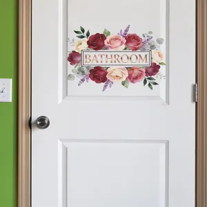 Close-up of elegant floral rose wall sticker with gold Bathroom text on door
