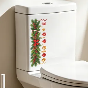 Festive Christmas toilet sticker with pine branches and red bow on white tank