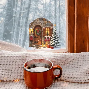 Cozy Christmas window sticker showing a snowy cottage scene with tree and gifts.